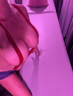 Celine sitting almost naked at a massage table