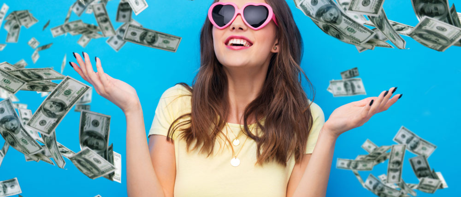 Young woman throws money in the air.